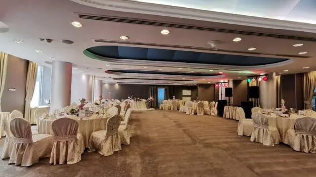 Hotel Minerva ballroom set for a formal banquet with round tables, perfect for wedding receptions.