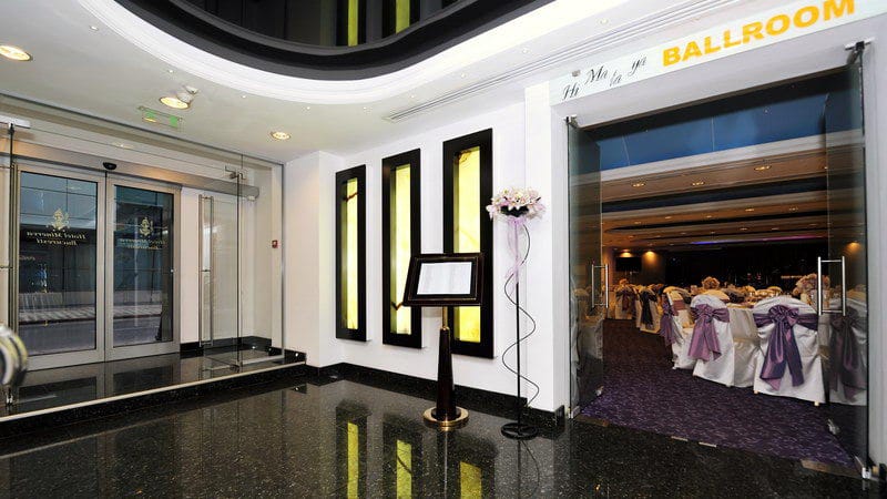 Hotel Minerva foyer with violet ballroom accents for corporate events and conferences.