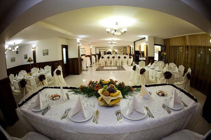 Banquet hall with formal table settings for wedding and corporate event hosting.