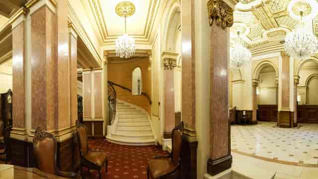 Historic hotel foyer with grand staircase, perfect for luxury corporate galas and wedding receptions.