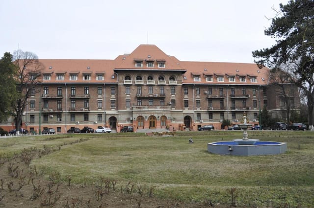 Hotel Triumf historic restaurant venue, grand facade for corporate retreat and academic conference.