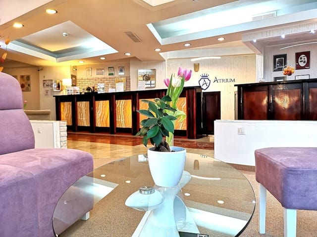 Cozy hotel lobby with traditional reception desk for intimate event registration and check-ins.