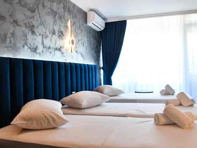 Triple room at Hotel Topaz, efficient guest layout for group travel and event accommodation.