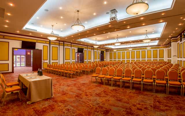 Ballroom in CARO Urban Resort with crystal chandeliers, ideal for corporate seminars and events.