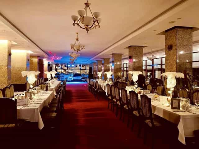 Banquet hall at Piatra Mare Resort with feather centerpieces for elegant gala or wedding event.