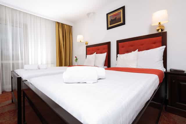 Twin hotel room at Piatra Mare Resort for corporate travel and conference accommodation.