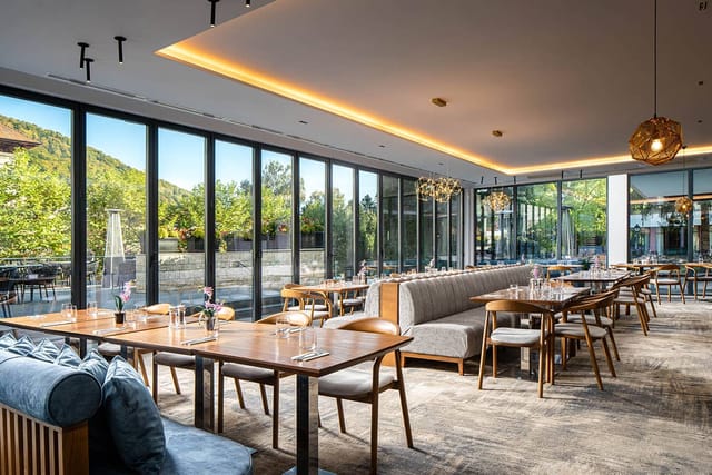 Elegant hotel private dining room with floor-to-ceiling glass for corporate retreats or networking.