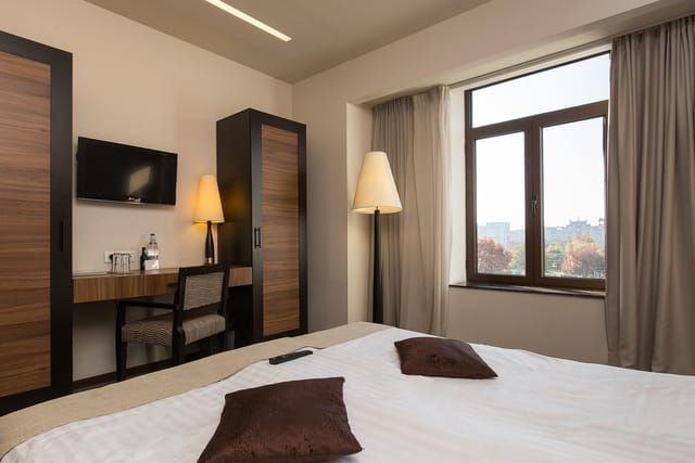 Europa Royale Bucharest hotel suite with workspace for business conferences and room blocks.