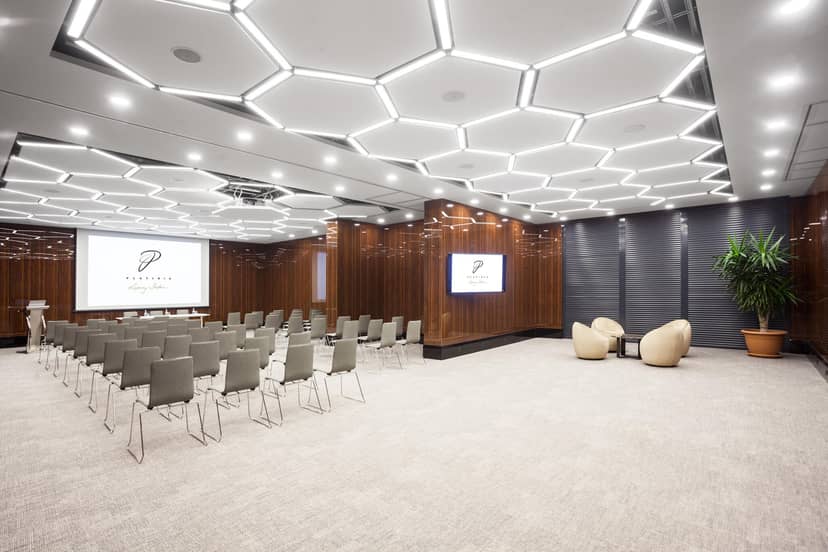 Verdi Meeting Room with hexagonal lighting, theater seating, and corporate breakout space.