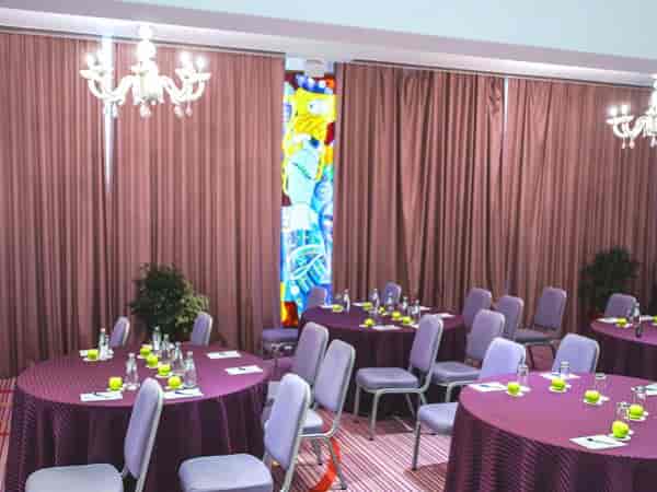 Panoramic Hall boardroom with stained glass wall for corporate meetings and breakout events.