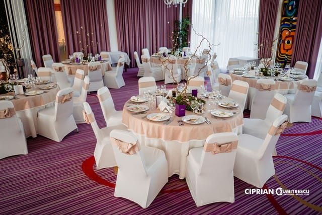 Panoramic Hall banquet setup with peach linens for wedding and corporate event hosting.