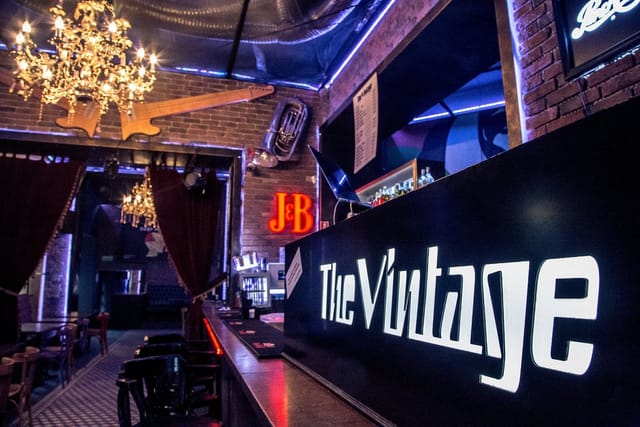 The Vintage Pub bar with ambient lighting, perfect for upscale event reception or brand launch.