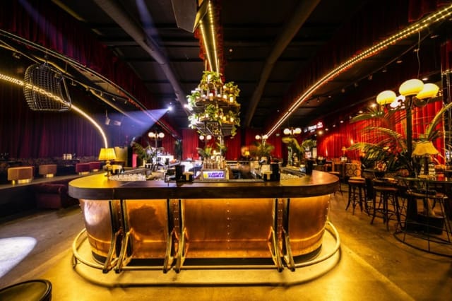 Fratelli Ristorante with velvet decor and central bar for upscale networking and evening soirées.