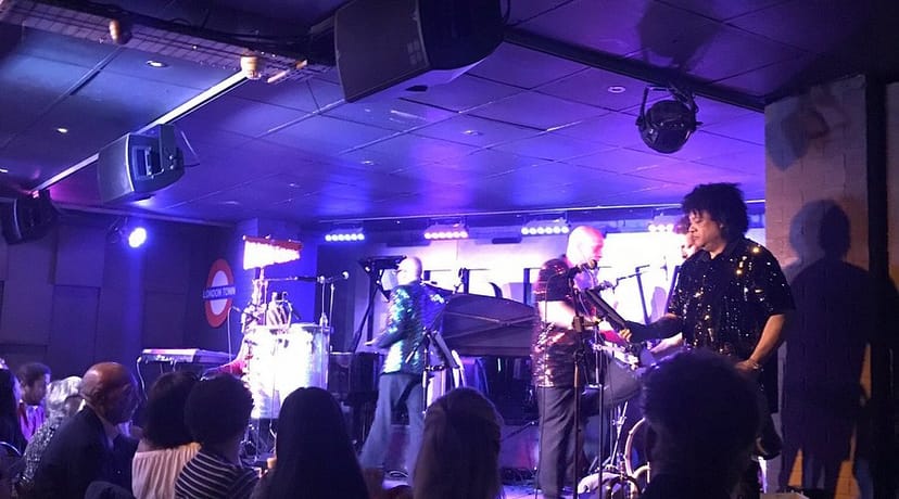 Live band at Hideaway bar with purple ambient lighting for corporate receptions and social mixers.