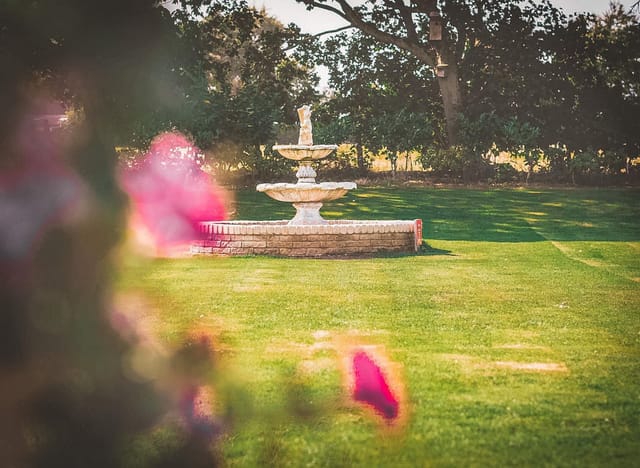 The Aviary garden event space featuring a tiered fountain for outdoor ceremonies and receptions.