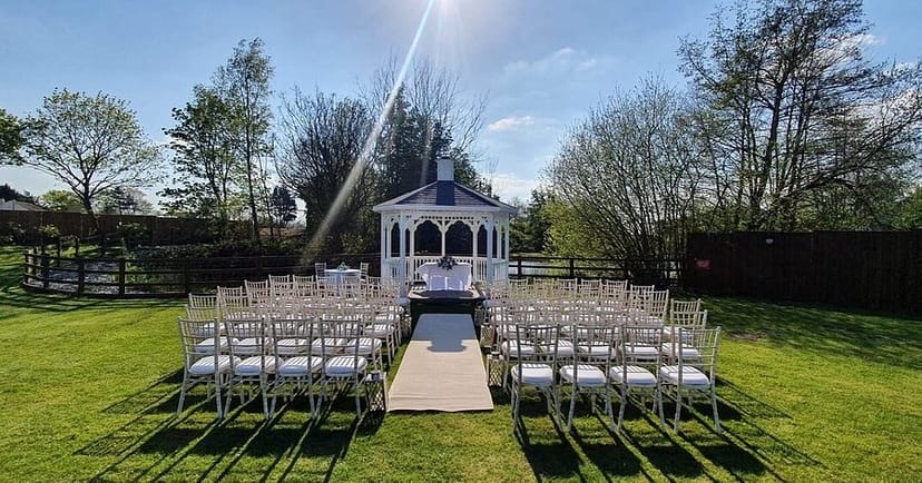 Outdoor wedding ceremony at The Aviary, classic gazebo, garden venue and event space.