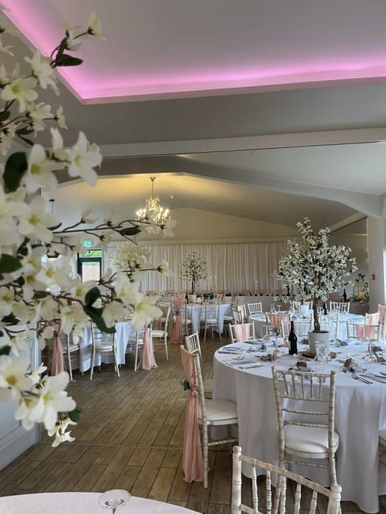 Wedding reception at The Aviary featuring elegant floral centerpieces for event venue booking.
