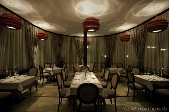 Private dining room at Hotel Epoque with circular table and pendant lighting for VIP board meetings.