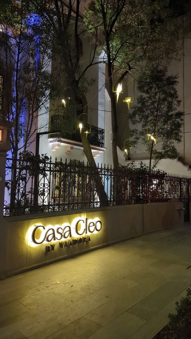 Boutique hotel exterior at Casa Cleo with ambient lighting for evening events and receptions.