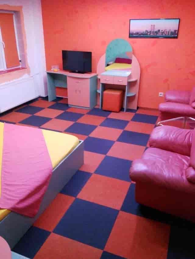 Superior room at Oana Accommodation with cluttered layout, ideal for corporate event travel.