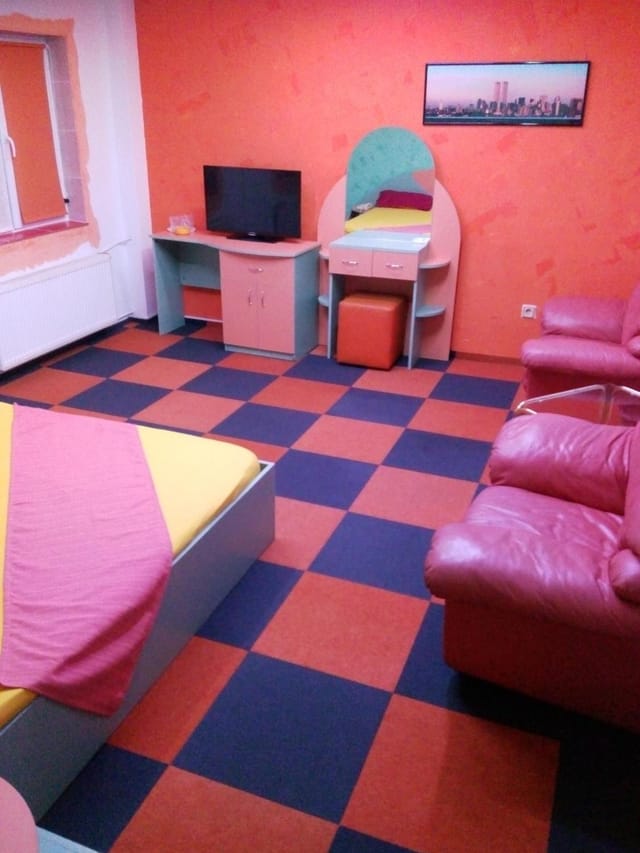 Superior room at Oana Accommodation with cluttered layout, ideal for corporate event travel.