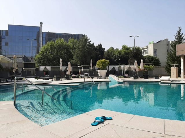 Ramada Plaza Bucharest outdoor pool deck for corporate networking events and conference receptions.