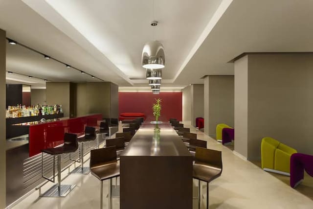 Ramada Plaza Bucharest hotel lounge with high-top seating for corporate events and networking.
