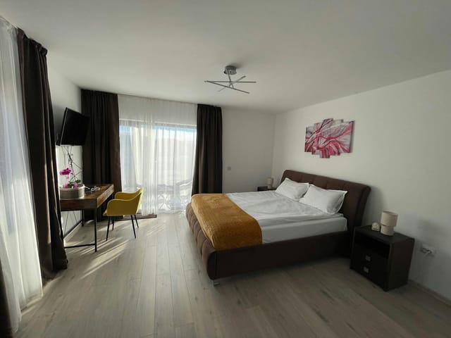 Minimalist hotel room with workspace for business travel at Casa Valentina Cristian.