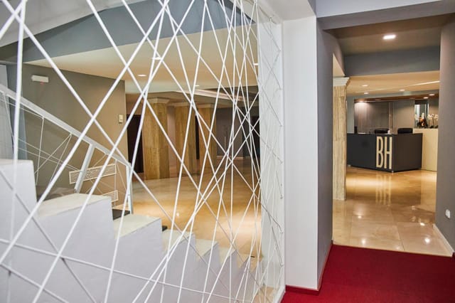 Modern hotel conference foyer with geometric room divider for business events and meetings.
