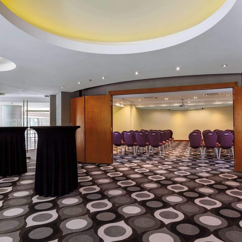 Meeting space at Sheraton Bucharest Hotel with purple chairs for events and presentations.