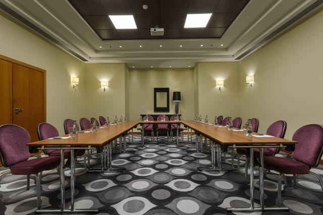 Meeting room at Sheraton Bucharest Hotel with U-shaped tables for workshops and conferences.