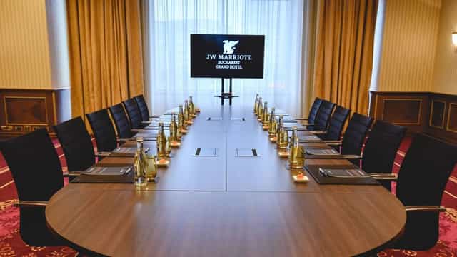 Conference room at JW Marriott Bucharest with oval table, ideal for corporate meetings.