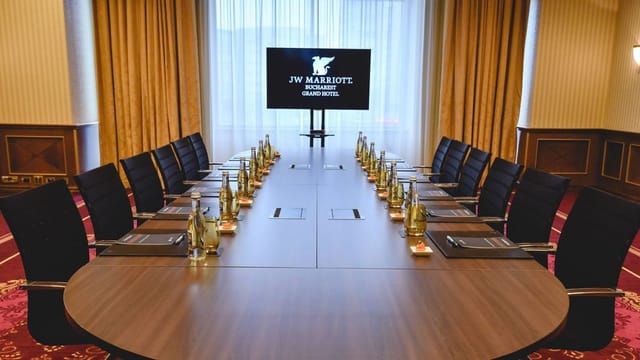 Conference room at JW Marriott Bucharest with oval table, ideal for corporate meetings.