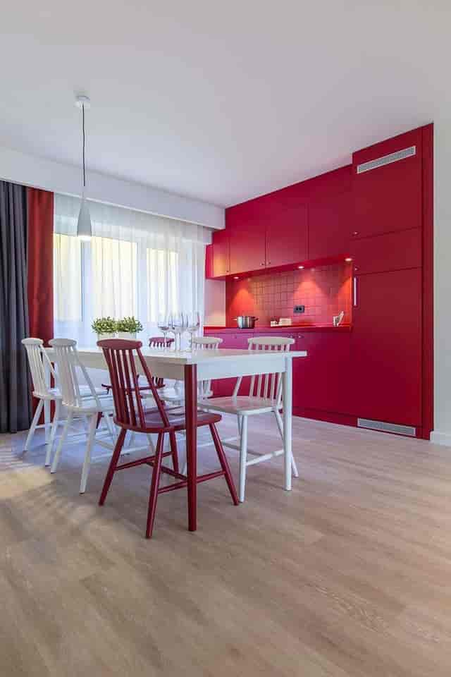 Modern meeting space at Park Inn Bucharest with vibrant red kitchen, ideal for workshops.
