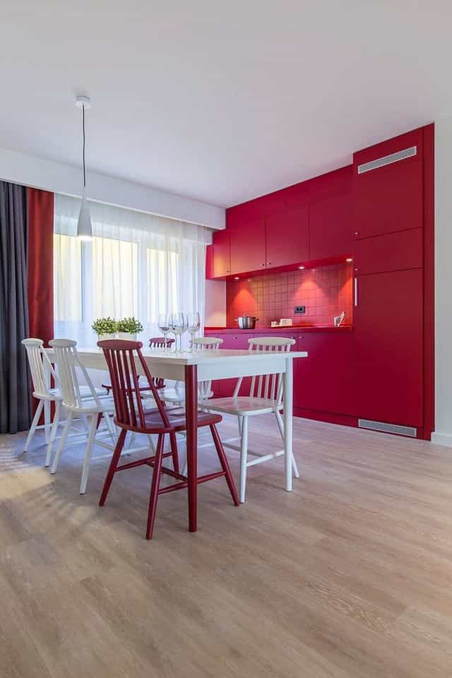 Modern meeting space at Park Inn Bucharest with vibrant red kitchen, ideal for workshops.