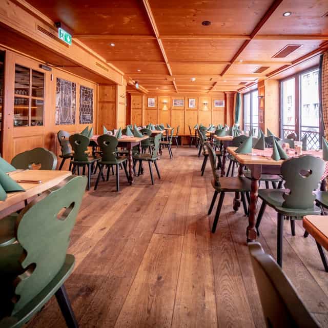 Spacious dining area in Bierkutscher-Stube, ideal for events and gatherings with wooden decor.