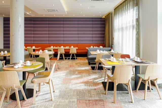 Modern dining area in Novotel München, ideal for meetings and events.