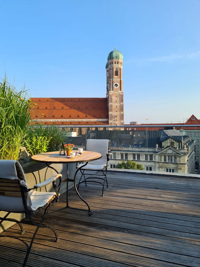 Rooftop terrace at Bayerischer Hof, lush greenery ideal for networking events.