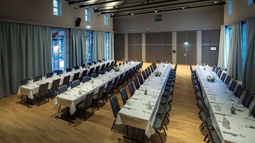 Function room at Platzl Hotel with formal dinner setup for corporate events and gatherings.