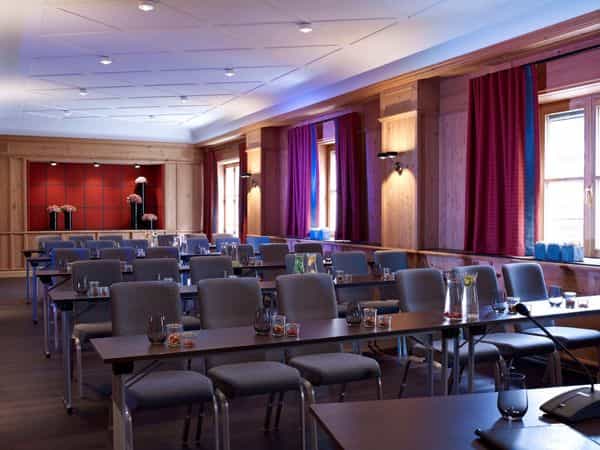 Conference room at Platzl Hotel with warm wood accents for workshops and seminars.