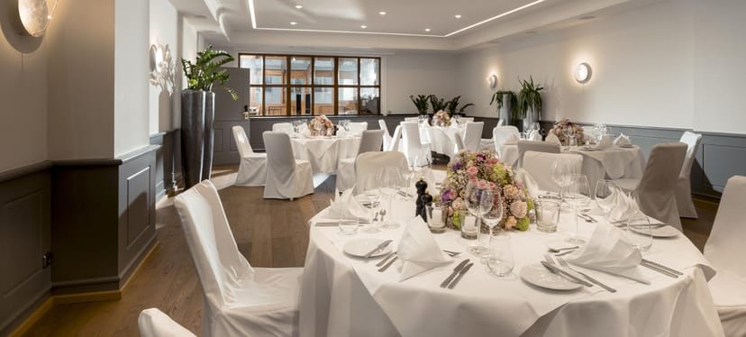 Upscale event space with elegant tables, ideal for weddings and corporate functions.