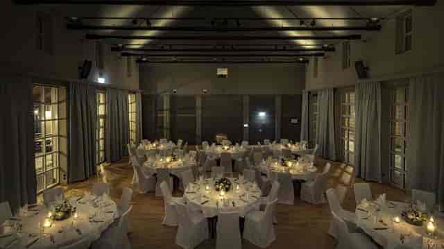 Elegant banquet hall with candlelit tables, perfect for weddings and celebrations.