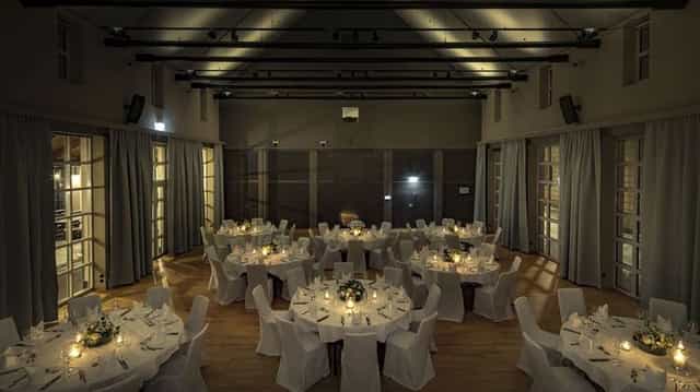 Elegant banquet hall with candlelit tables, perfect for weddings and celebrations.