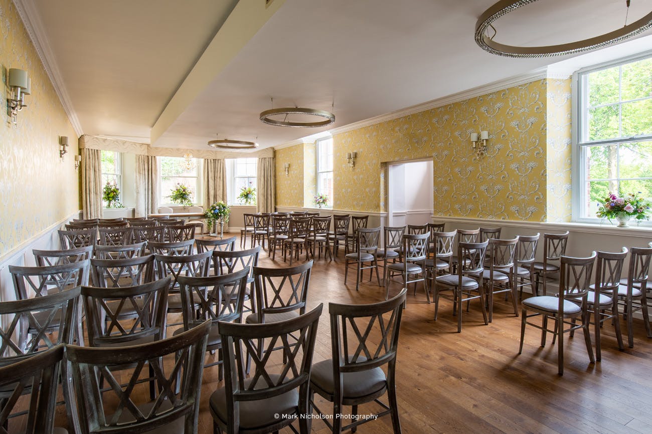 The River Room in Old Palace Chester, elegant event space with wooden chairs for gatherings.