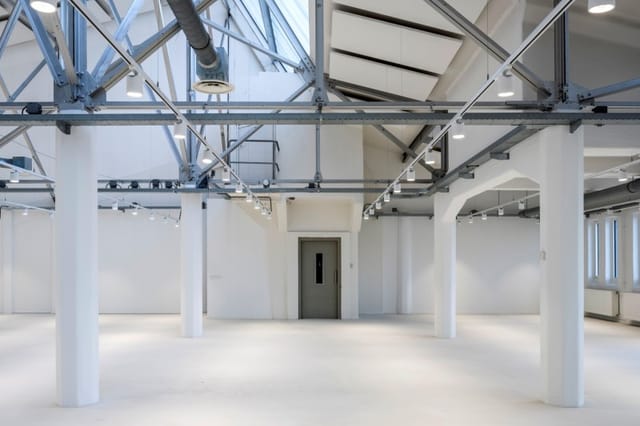 Industrial-chic event venue with high ceilings for product launches and pop-up exhibits.