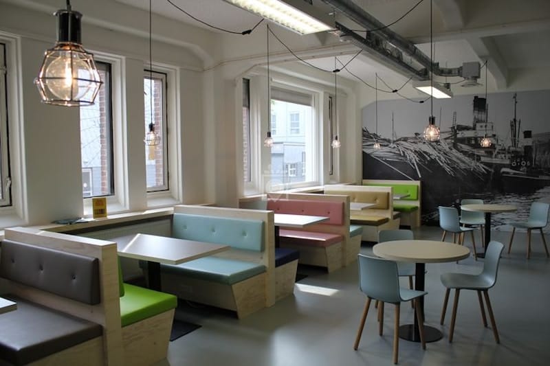 Modern meeting room with booth seating for corporate workshops and networking events.