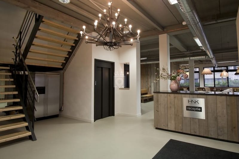 Modern industrial reception area at HNK Amsterdam Houthavens for corporate event registration.
