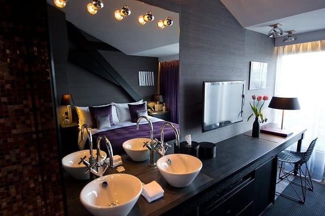 Luxury hotel room with open bathroom for VIP corporate events and executive retreats.