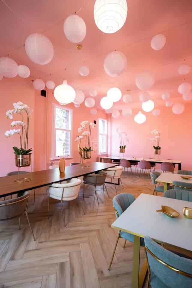 Modern coworking event space with statement lighting for corporate networking and creative workshops.