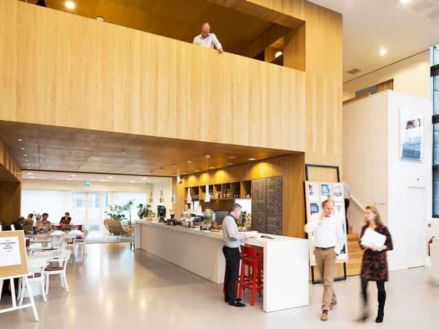 Modern breakout area with coffee station for hybrid networking and conference events.